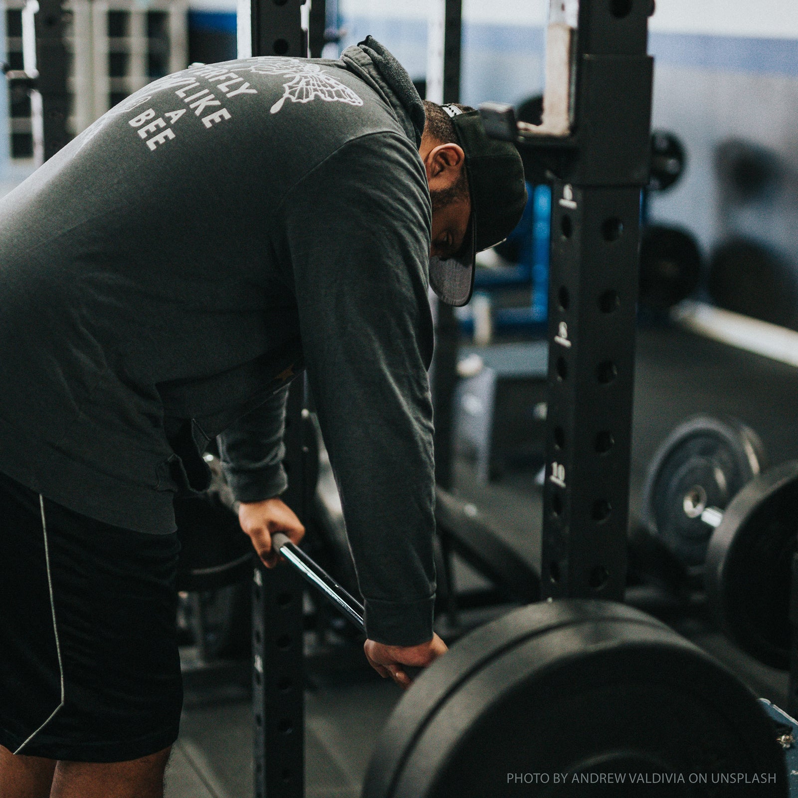 Male weightlifter resting hands on barbell