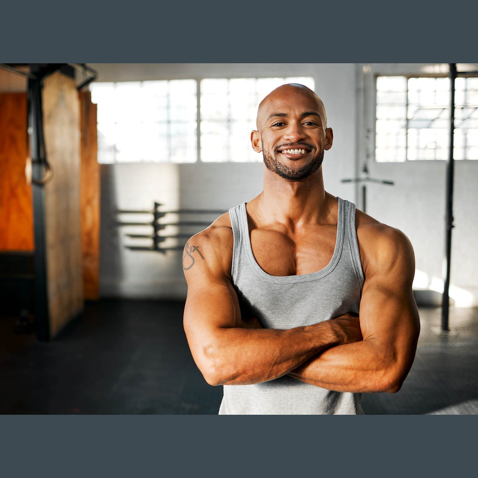 Muscular black male athlete stands proud of his accomplishments